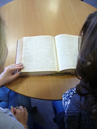 A-level students using a 1785 dictionary during an outreach workshop